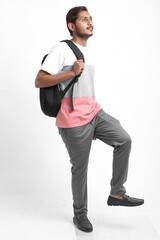 handsome indian college student carrying bag on white background.
