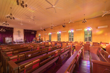 Interior of empty christian church with cross, architecture design. Religious beliefs. Catholic religion. Jesus worship.