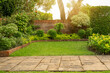 Back - front yard English cottage garden, green grass lawn, colorful flowering plant