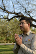 © ULTRAPOK - A Thai government officer, Civil servant is standing with hands clasped respect.