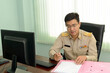 © ULTRAPOK - A Professional level Thai government officer, Civil servant signing the document on file.