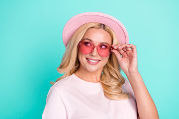 Portrait of attractive cheerful wavy-haired woman touching specs looking copy space isolated over bright teal turquoise green color background