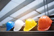 © Rapeepat - Safety Construction Worker Hats Blue, white, yellow, orange. Teamwork of construction team must have quality. Whether it engineer, construction workers. Have a helmet to wear at work. Safety at work.