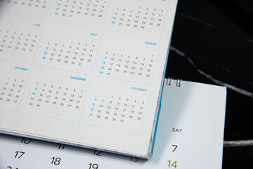 Blurred calendar on black  background.