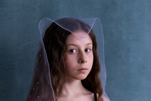 Closeup Old Master Style Studio Shot Of Beautiful Little Girl With Pale Blue Sheer Scarf On Her Head

