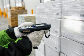 Bluetooth barcode scanner checking goods in the cold room or warehouse. Selection focus shooting on Bluetooth barcode scanner.