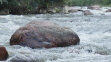 River Water Passing By Rock In Slow Motion