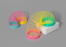Rainbow Plastic Spring Toy With Shadows On Gray Background