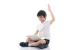 © lalalululala - Asian Boy using laptop and raise your hand while sitting on white background isolated