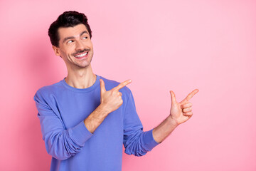 Poster - Photo of brunet optimistic guy point look empty space wear blue shirt isolated on pink color background