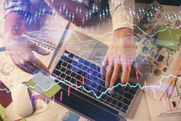 Double exposure of man and woman working together and forex graph hologram drawing. Financial analysis concept. Computer background. Top View.