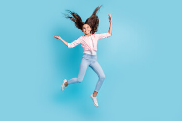 Sticker - Full size photo of energetic cheerful school person jumping hair flying good mood isolated on blue color background