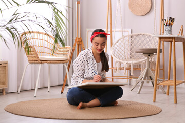 Sticker - Happy woman artist drawing picture on canvas in studio