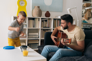 Wall Mural - father and son having fun at home