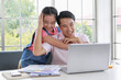 © Bangkok Click Studio - Happy little ethnic girl hugging father working online from home