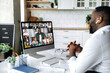© Kateryna - Video conference. online meeting. Intelligent African American business man sits at work desk at home, looks at the computer screen, communicates by video call with his partners, discuss a strategy