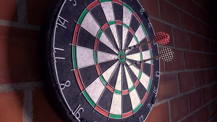 Wall Mural - Dartboard on a brick wall. Three darts hit the target. 