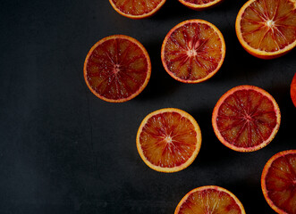 Poster - blood oranges on dark stone surface