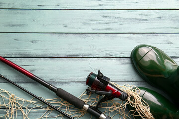 Different fishing equipment on color wooden background