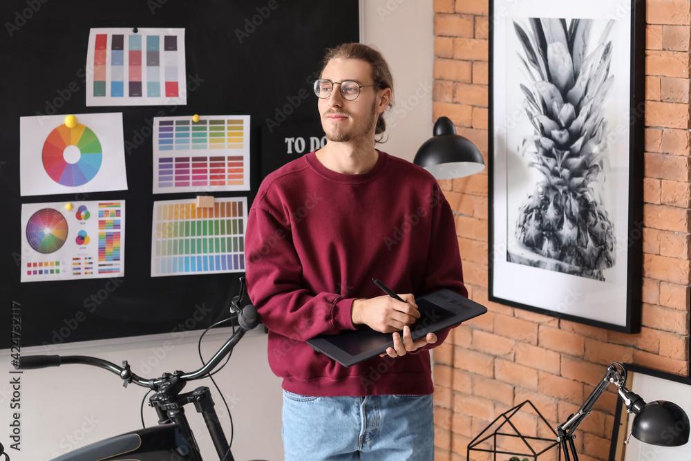 Young male designer working in office