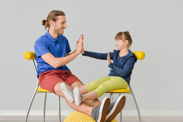 Wall Mural - Portrait of father and daughter playing at home