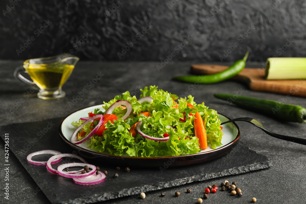 Plate of fresh salad with vegetables on dark background