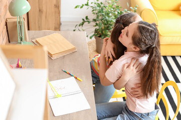 Poster - Cute twin girls sitting at table in room