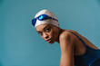 © Drobot Dean - Young black swimmer in goggles posing and looking at camera