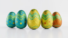 Easter Eggs Isolated Against A White Background. Chocolate Eggs Wrapped In Patterned Turquoise, Yellow And Orange Foil. 3D Render