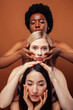 © iordani - young pretty asian, caucasian, afro woman posing cheerful together on brown background, lifestyle diverse nationality people concept
