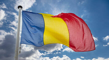 Sticker - Romanian flag waving against blue cloudy sky