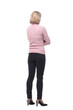 © ASDF - Back view of standing blonde woman in jeans and sweater