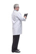 © ASDF - Back view of a doctor writing something on a blank paper of a clipboard