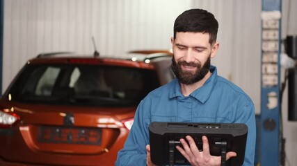 Canvas Print - Mechanic uses a tablet at the car service