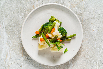 boiled vegetables on the white plate