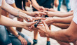 © Александра Вишнева - Close-up of the hand of people who are holding 1 stick all together. Team building event