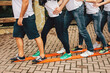 People stand with their feet on common wooden skis and move forward together. Teambuilding