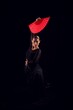 flamenco woman with black dress and red fan above her head