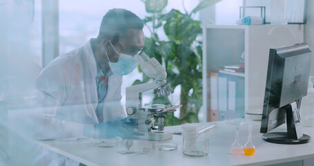 In medical center office afro-american biologist doctor examining infection bacteria and developing vaccine. Laboratory. General practitioner. Microbiology.