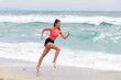 © Sergey Chumakov - attractive athletic woman running on beach sea coastline at morning