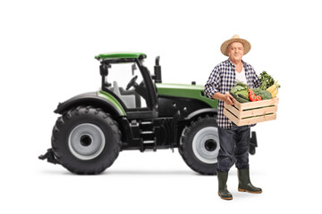 Poster - Elderly farmer with a tractor carrying a wooden crate full of vegetables