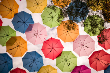 colorful floating umbrellas hang above the street. umbrella sky project in coral gables, miami, flor