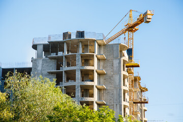 construction of iron-concrete high-rise building. Construction workplace in the summer. Details of unfinished building on the construction site. The erection of a new  residential multi-storey house