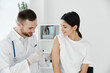 © SHOTPRIME STUDIO - doctor giving a shot to a woman in the shoulder vaccination epidemic hospital