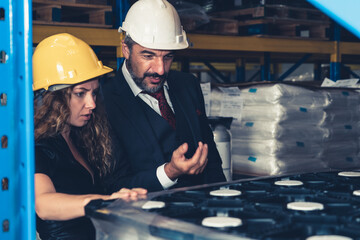 Warehouse senior manager talking to worker in the storehouse . Logistics , supply chain and warehouse business concept .