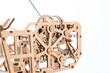 The mechanism of a toy crane made of wood on a white background