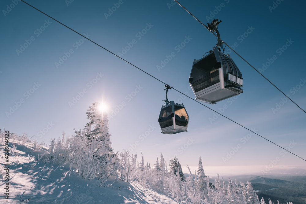 gondola ski lift in mountain ski resort, winter day, snowy spruce forest - obrazy, fototapety, plakaty 