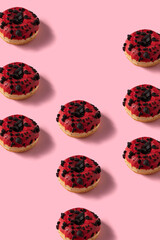 Wall Mural - Red velvet donuts  pattern image. Many Donuts on pink vertical background.