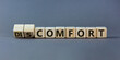From discomfort to comfort symbol. Turned a cube and changed the word 'discomfort' to 'comfort'. Beautiful grey background, copy space. Business and from discomfort to comfort concept.