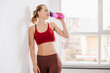 © rostyslav84 - Woman after training posing with water bottle at the gym